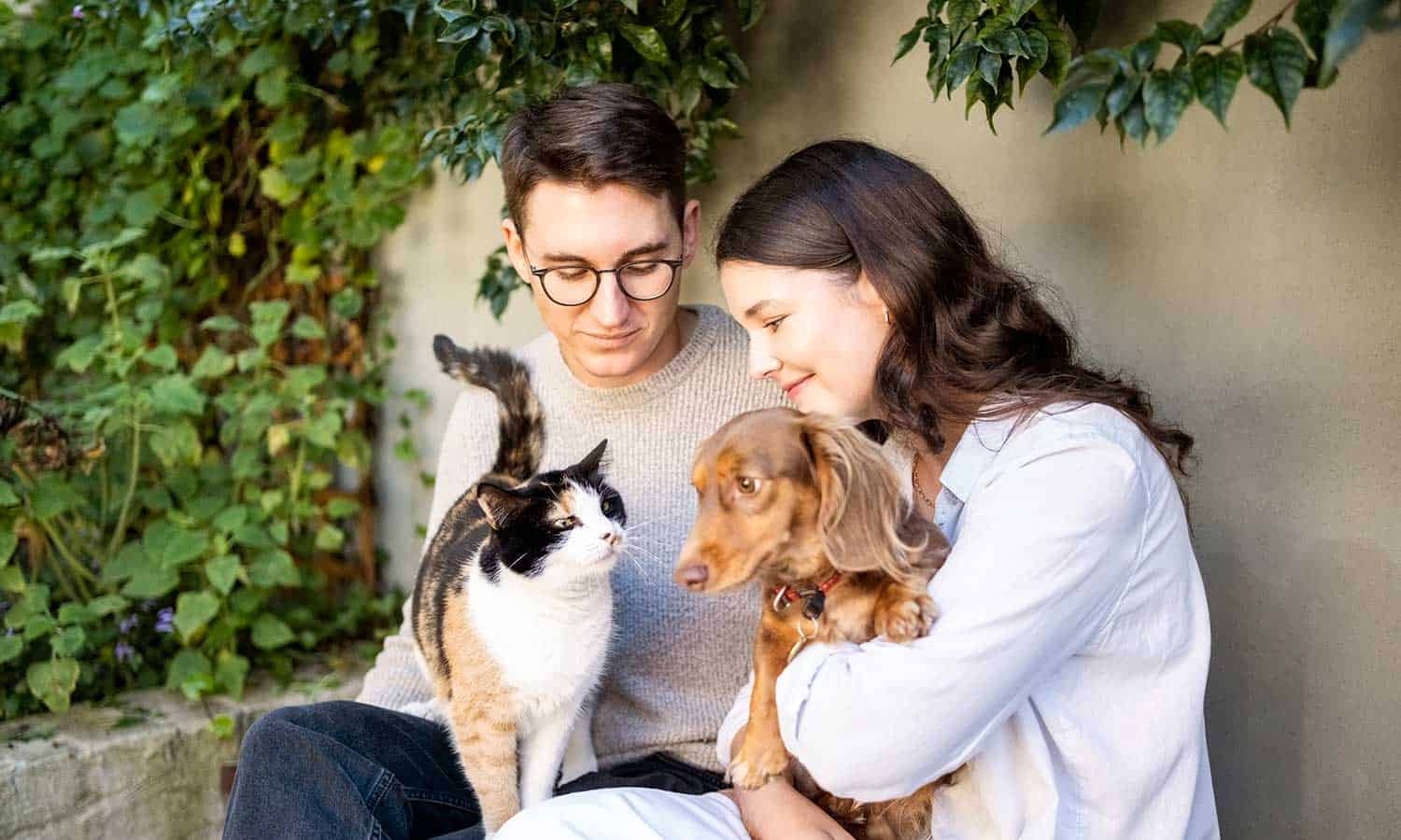 A family with their cat and dog